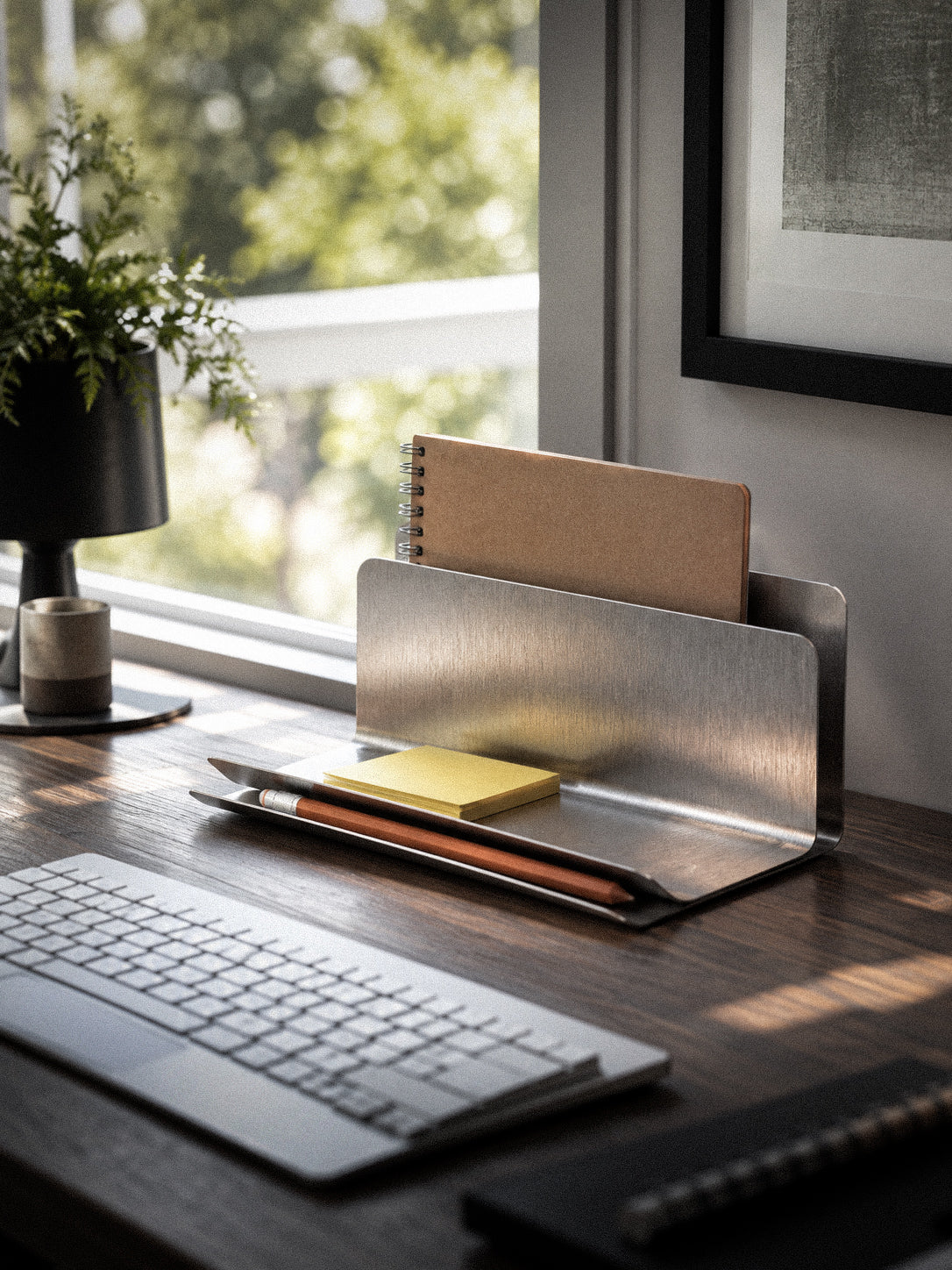 FORM/17 Desk Dock holding a notebook, sticky notes and a pencil on a sunlit desk